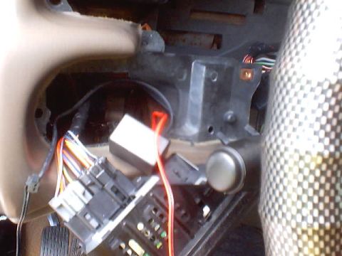 1999 Ford Taurus - Close-up of the interior fuse box and wiring harness, showing various colored wires and electrical components.