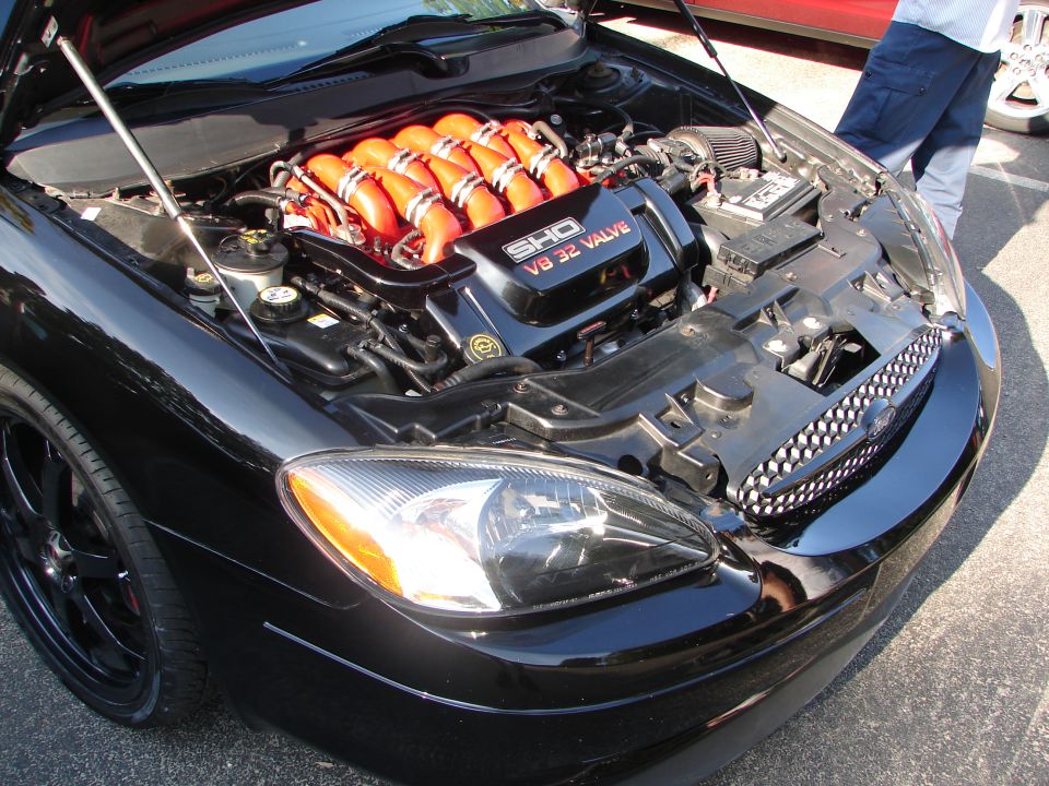 Black Ford Taurus front with SHO V8 32 valve engine visible