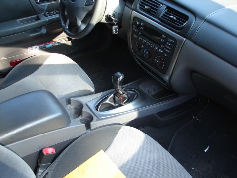 1992 Ford Taurus - Interior view of a car's dashboard, center console, and front seats.