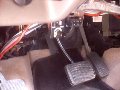 1999 Ford Taurus - Interior view of car pedals and exposed wiring under the steering column.