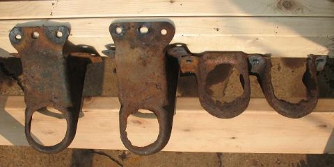 1978 Ford Bronco - These heavily rusted metal brackets are presented on a wooden surface, with visible text from Supermotors.net.