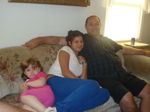 2000 Ford Crown Victoria - A family enjoys a moment together on the sofa.