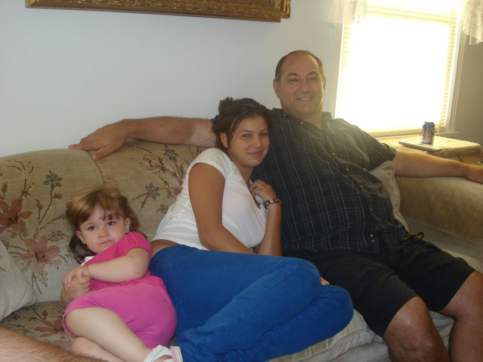 Family of three sitting on a couch