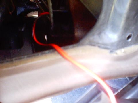 1999 Ford Taurus - A red wire is visible within the vehicle's interior, near a panel.