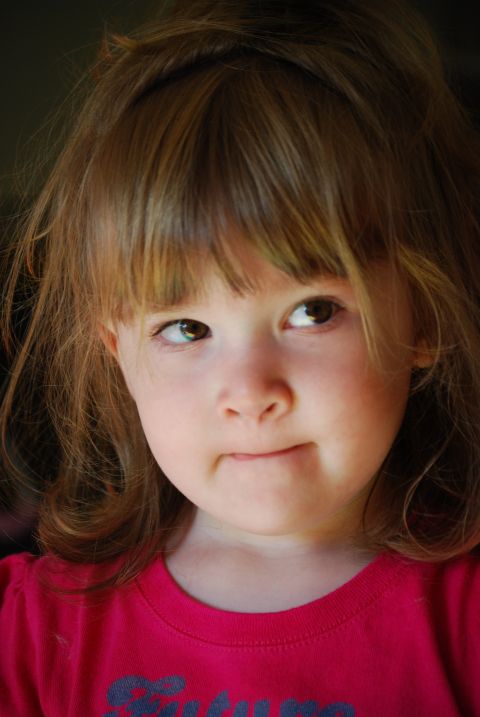 2000 Ford Crown Victoria - A young girl with brown hair looks away from the camera with a thoughtful expression.