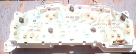 1999 Ford Taurus - Circuit board for a vehicle's instrument cluster, showing electrical connections and components.