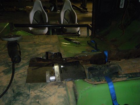 1978 Ford Bronco - The interior of a green vehicle is shown, racing seats and modifications.
