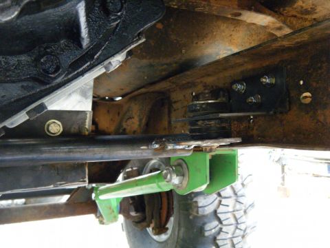 1978 Ford Bronco - Close-up view of modified suspension parts on a vehicle frame, with visible text from Supermotors.net.