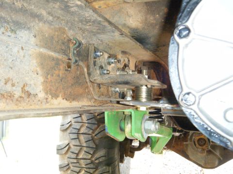 1978 Ford Bronco - Custom suspension modification shown on a vehicle's undercarriage, with visible rust and a tire.