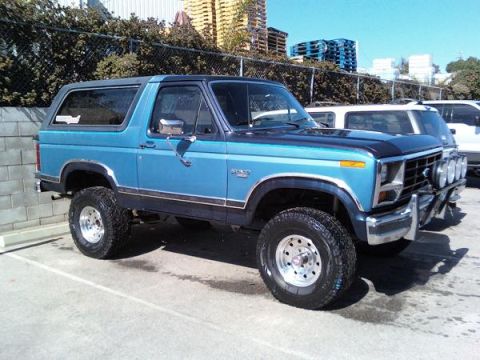 1984 Ford Bronco - This blue 1984 Ford Bronco features a two-tone paint scheme and auxiliary driving lights mounted on the front bumper.