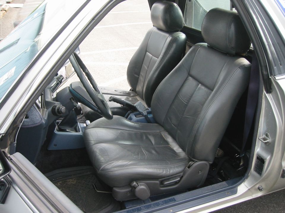 Car interior showing front leather seats and dashboard