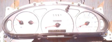 1999 Ford Taurus - This instrument cluster features a speedometer, tachometer, and fuel gauge, with an odometer displaying 1117 miles.