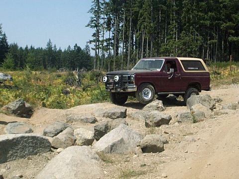 1986 Ford Bronco - This Ford Bronco is navigating a rocky obstacle course on a sunny day.