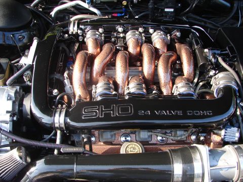 1992 Ford Taurus - Close-up of a SHO 24 Valve DOHC engine, polished intake runners and black valve covers.