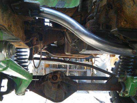 1978 Ford Bronco - This photo shows the heavily modified undercarriage of an off-road vehicle, including its suspension and exhaust system.