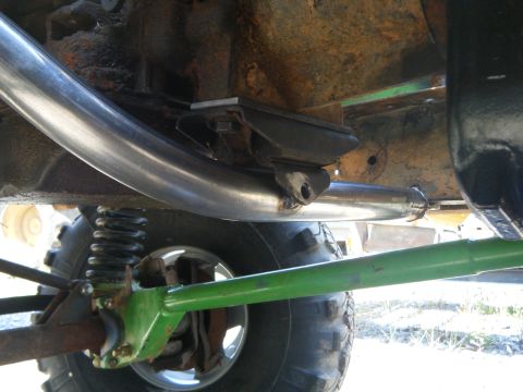 1978 Ford Bronco - Undercarriage view shows modified exhaust and suspension components on a vehicle.