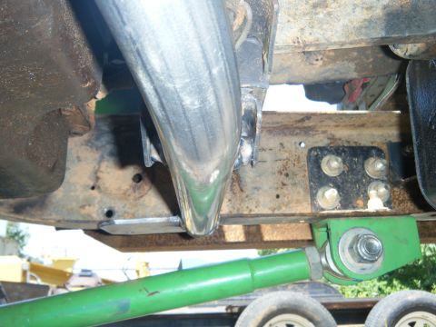 1978 Ford Bronco - Custom suspension modifications are visible on the undercarriage, including a bright green control arm and a polished exhaust pipe.