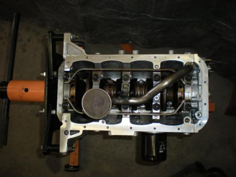 2009 Suzuki Samurai - Engine block assembly shown with the oil pan removed, revealing internal components.