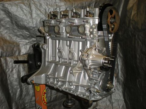 2009 Suzuki Samurai - This engine is mounted on a stand, showing the timing belt and water pump assembly.