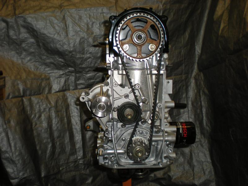 Engine block with timing belt, pulleys, and oil filter. Bosch oil filter visible
