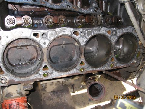 1994 Ford Bronco - Close-up view of an engine's cylinder block and pistons, indicating internal engine components.