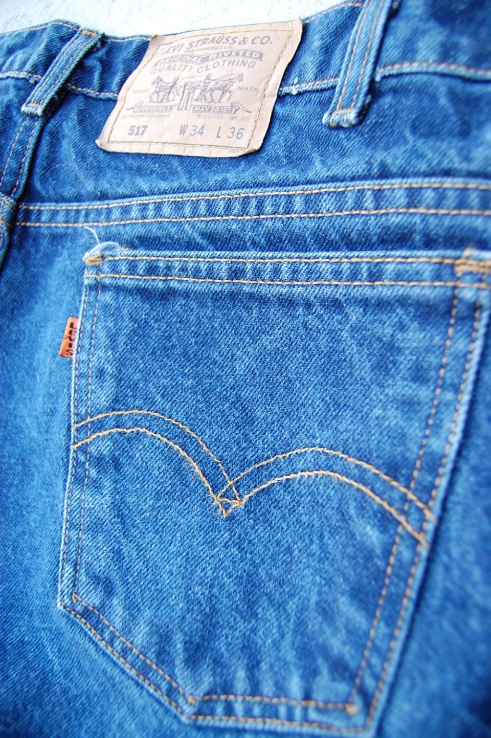 Close-up of blue jeans back pocket with Levi Strauss & Co. label showing size W34 L36