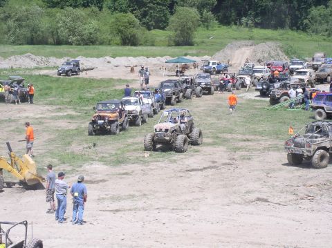 1979 Ford Bronco - A large gathering of off-road vehicles in an outdoor event space.