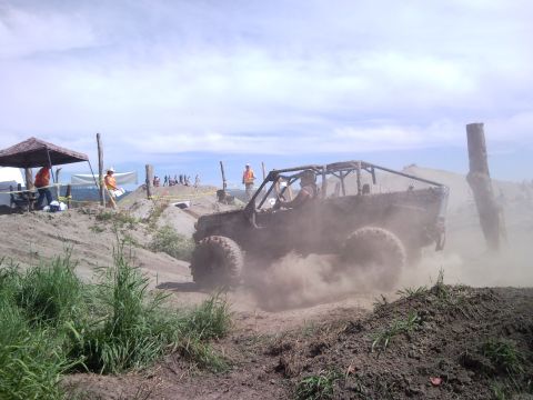 1979 Ford Bronco - An off-road vehicle kicks up dust as it navigates a challenging dirt course.