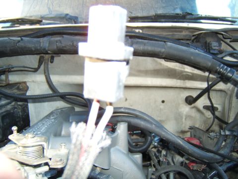 1988 Ford Bronco - Close-up of an engine bay with a white electrical component and wiring visible.