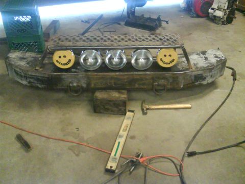1984 Chevrolet Blazer - A custom bumper with auxiliary lights and a metal grate is shown in a workshop setting.