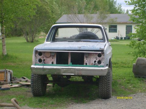 1984 Chevrolet Blazer - This light blue pickup truck is missing its grille and headlights, sitting in a grassy yard.