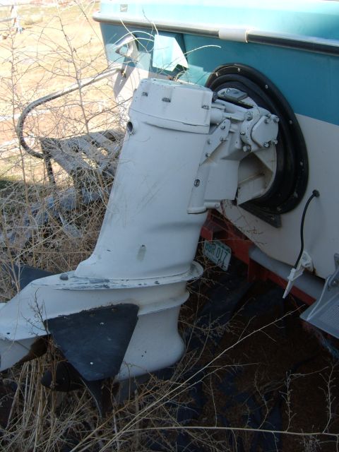 1988 Chevrolet Suburban - Outboard motor unit on a boat, showing the lower unit and propeller.