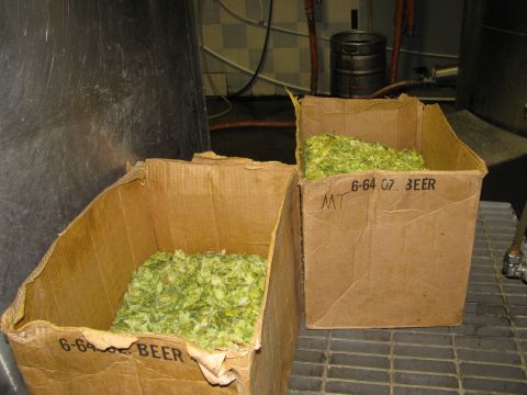 1985 Ford LTD Crown Victoria - Cardboard boxes filled with hops, likely for brewing. Text on one box indicates 'BEER'.