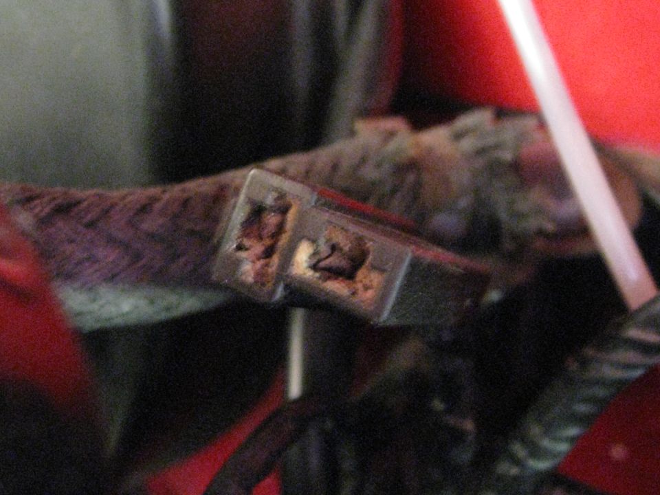 Close-up of a damaged electrical connector with frayed wires