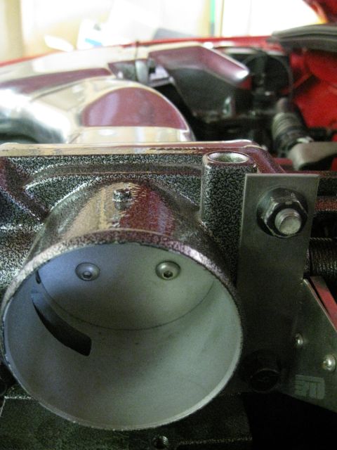 1994 Ford Probe - A close-up view of a vehicle's throttle body, showing internal components and mounting hardware.