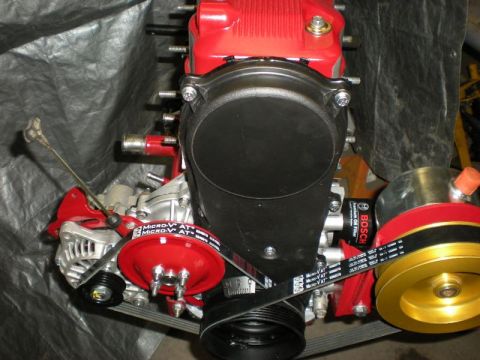 Suzuki Samurai - Close-up view of an engine's timing belt cover, alternator, and a Bosch oil filter.