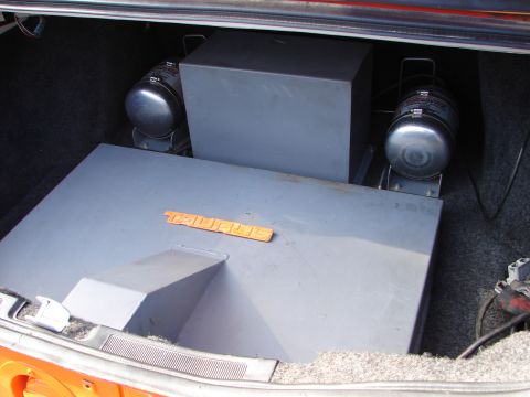 1992 Ford Taurus - Custom trunk setup with air compressors and a Taurus badge is visible in this photo.
