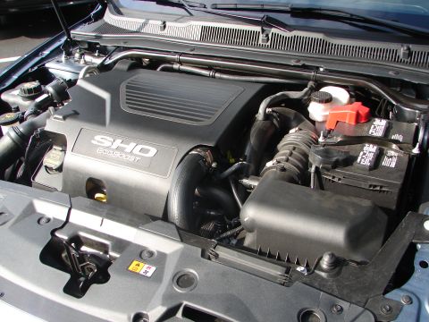 1992 Ford Taurus - Engine bay of a Ford SHO EcoBoost, showing the engine cover and battery.