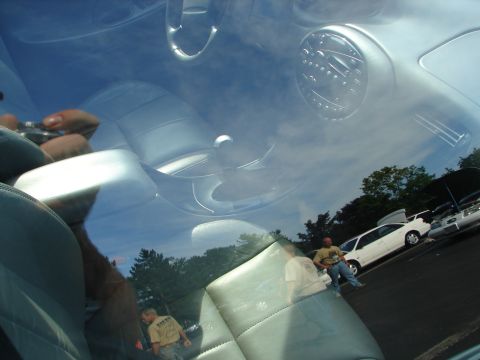 1992 Ford Taurus - Reflection shows multiple cars and people outside the vehicle, viewed from the interior.