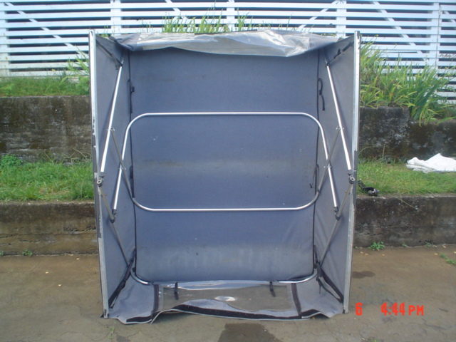 Gray fabric soft topper/tent with aluminum frame on concrete outdoors