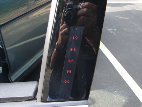 1992 Ford Taurus - Close-up of a car's exterior door panel, showing a keypad with illuminated numbers.