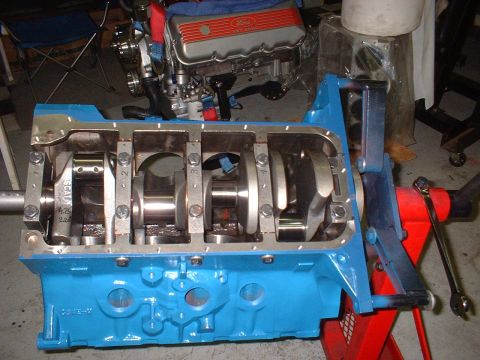 1968 Ford Galaxie - Engine block assembly with crankshaft and connecting rods, a Ford valve cover in the background.