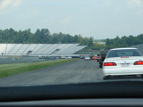 1992 Ford Taurus - White 1992 Ford Taurus in line on a racetrack with other vehicles.