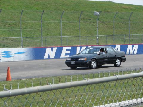 1992 Ford Taurus - A 1992 Ford Taurus sedan navigates a turn on a race track.