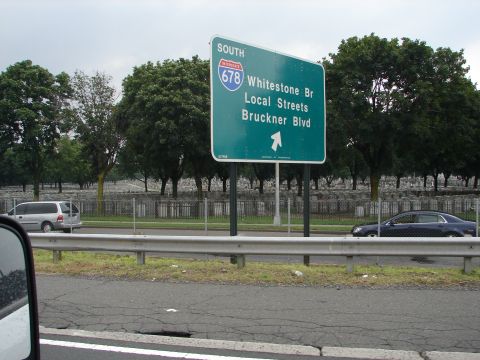 1992 Ford Taurus - Highway sign indicates directions to Whitestone Bridge and Bruckner Blvd, with two vehicles visible on the road.