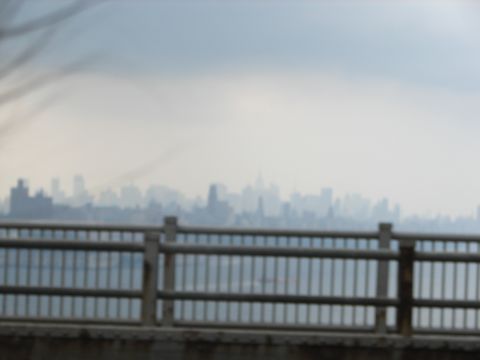 1992 Ford Taurus - A hazy cityscape is visible behind a wooden railing, with a website logo in the corner.