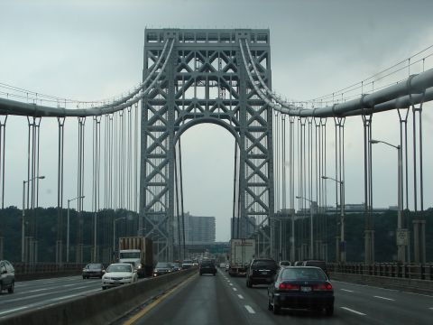 1992 Ford Taurus - Vehicles drive across a bridge under a large suspension tower on an overcast day.