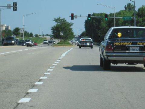 1991 Ford Crown Victoria - Highway Patrol Crown Victoria driving on a sunny day.