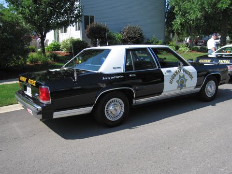 1991 Ford Crown Victoria - Side view of a black and white 1991 Ford Crown Victoria marked as Highway Patrol.