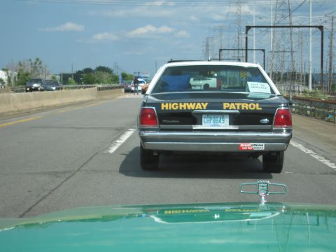 1991 Ford Crown Victoria - Rear view of a 1991 Ford Crown Victoria marked as Highway Patrol, seen on the road.